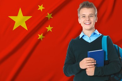 Image of Student with backpack and book against flag of China. Language school