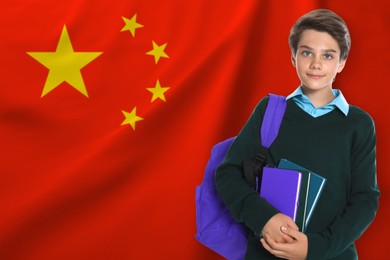Image of Student with backpack and books against flag of China. Language school