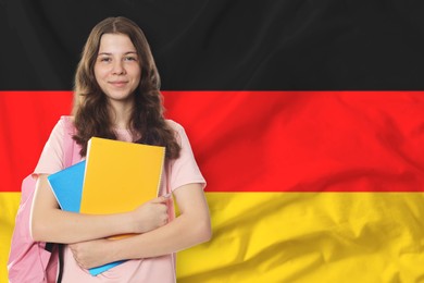 Image of Student with notebooks and backpack against flag of Germany. Language school