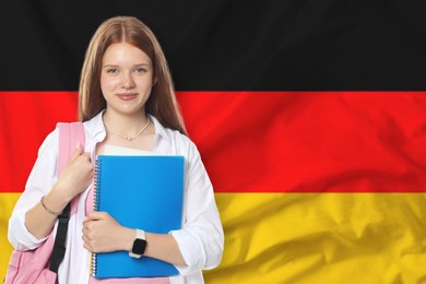 Image of Student with notebooks and backpack against flag of Germany. Language school
