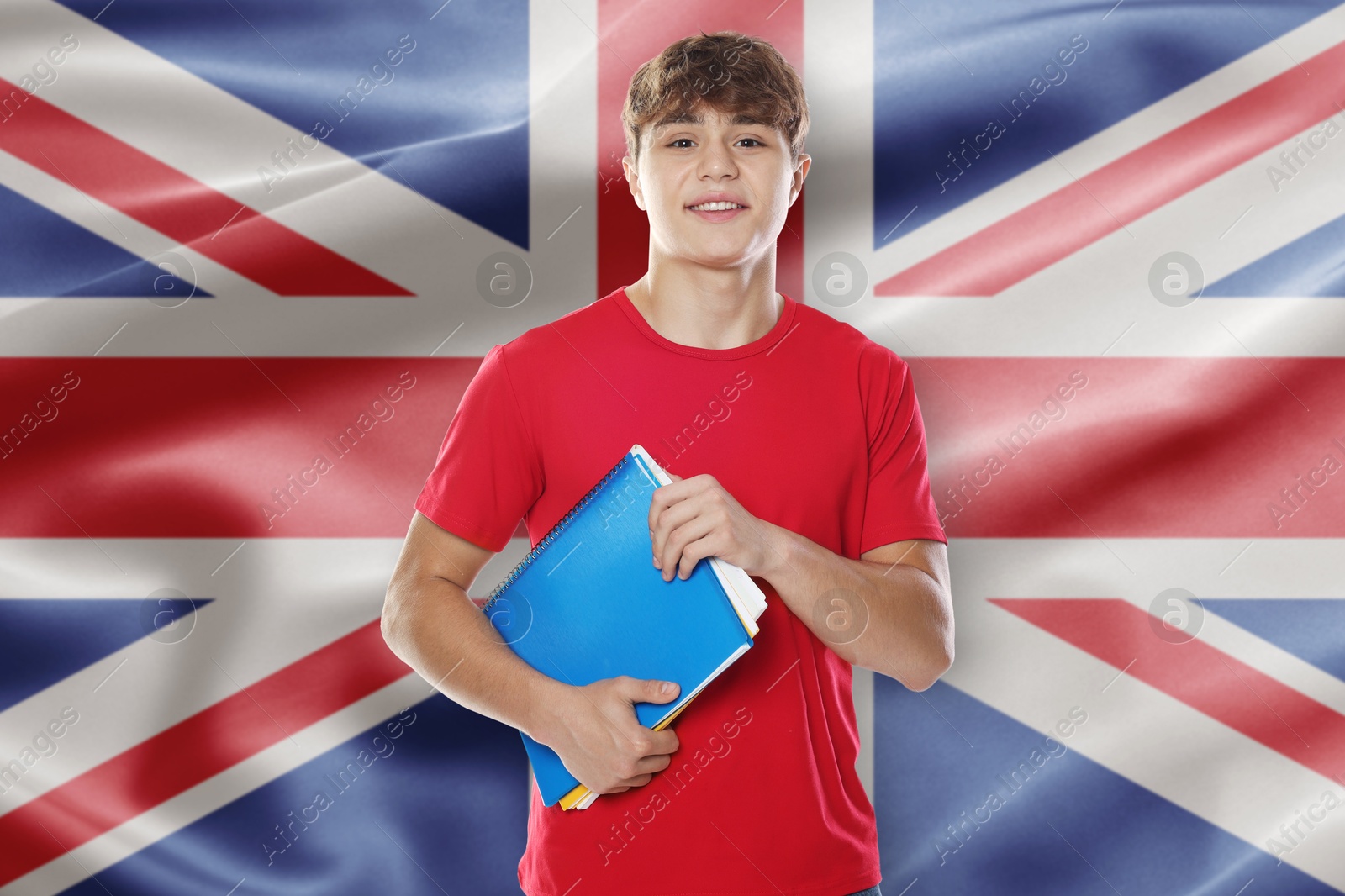 Student with notebooks against flag of United Kingdom. Language school Image of Student with notebooks against flag of United Kingdom. Language school
