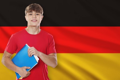 Image of Student with notebooks against flag of Germany. Language school