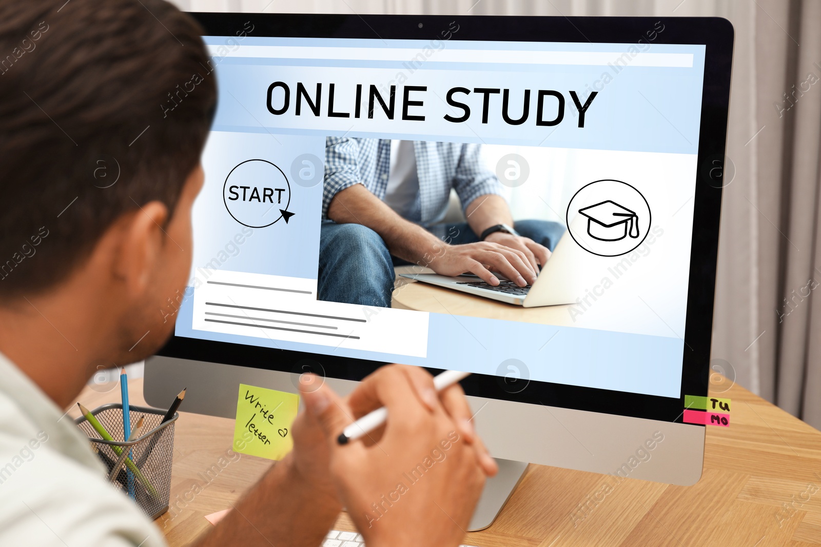 Image of Online study. Man using computer for e-learning at desk, closeup