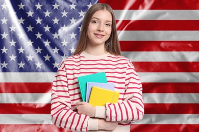 Image of Student with notebooks against flag of USA. Language school