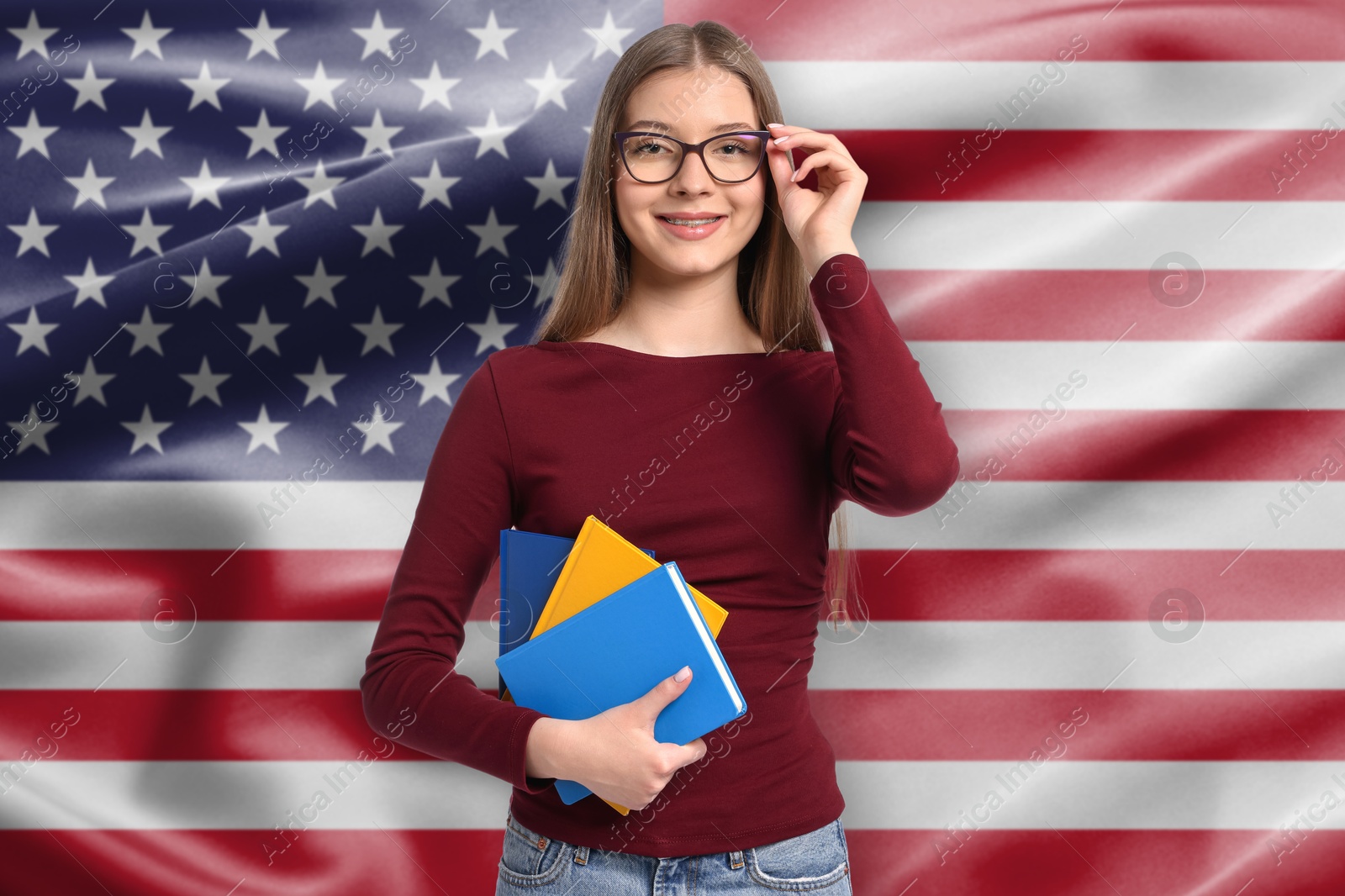 Student with notebooks against flag of USA. Language school Image of Student with notebooks against flag of USA. Language school