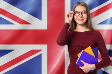Image of Student with notebooks against flag of United Kingdom. Language school