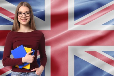 Image of Student with notebooks against flag of United Kingdom. Language school