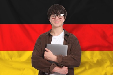 Image of Student with laptop against flag of Germany. Language school