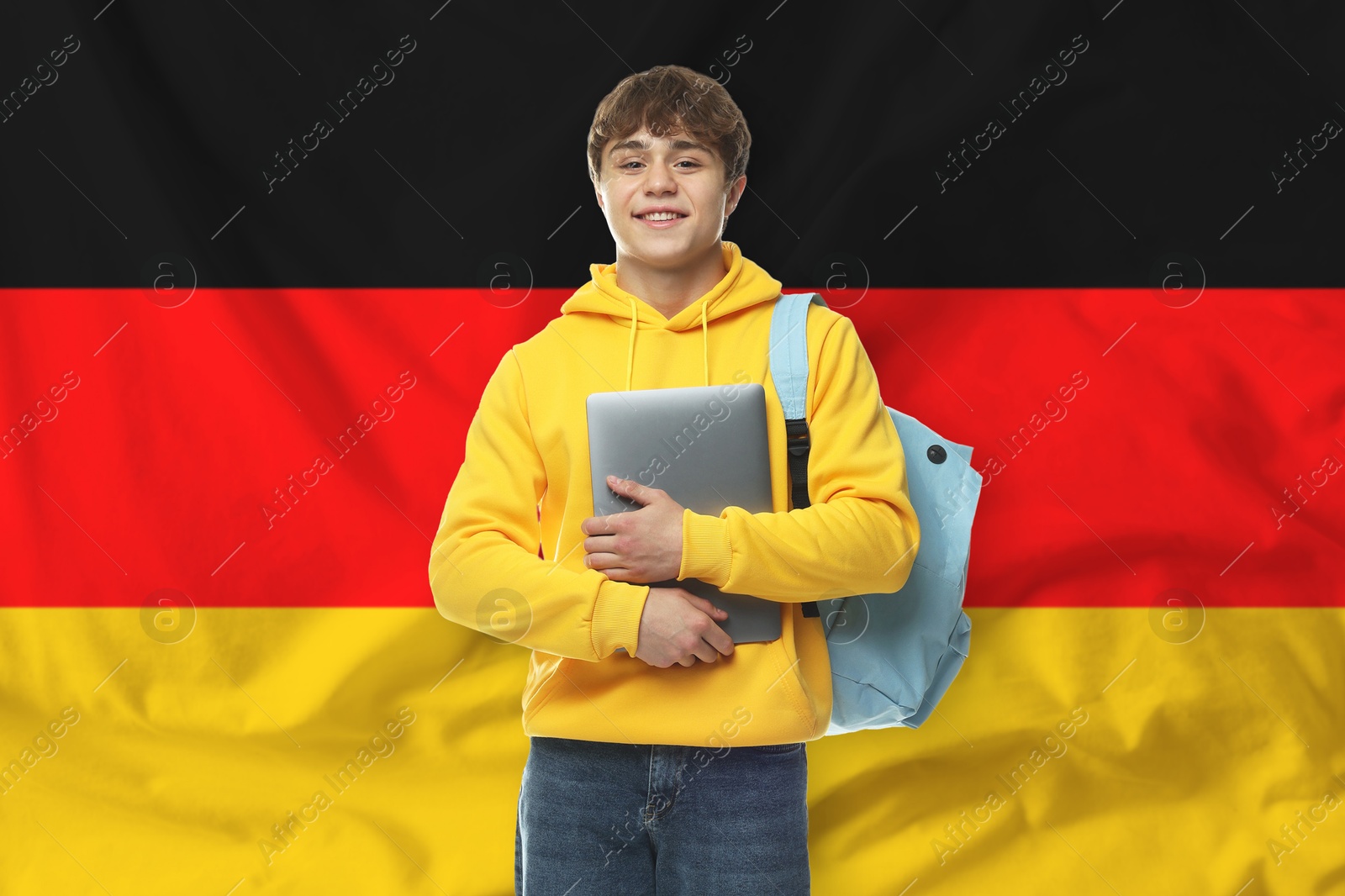 Student with laptop and backpack against flag of Germany. Language school Image of Student with laptop and backpack against flag of Germany. Language school