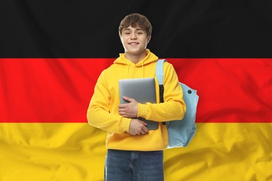 Image of Student with laptop and backpack against flag of Germany. Language school