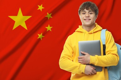 Image of Student with laptop and backpack against flag of China. Language school