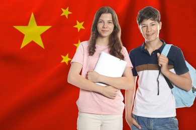 Image of Students against flag of China. Language school