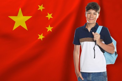 Image of Student with backpack against flag of China. Language school