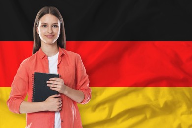 Image of Student with notebook against flag of Germany. Language school