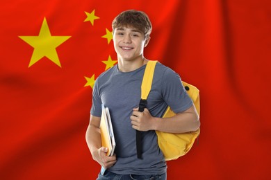 Image of Student with notebooks and backpack against flag of China. Language school