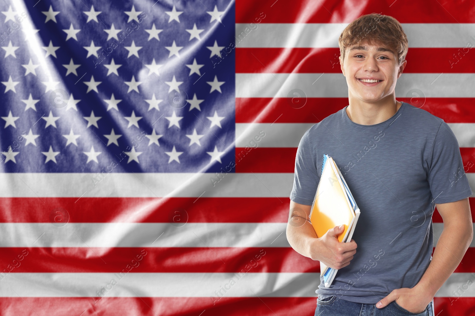 Student with notebooks against flag of USA. Language school Image of Student with notebooks against flag of USA. Language school
