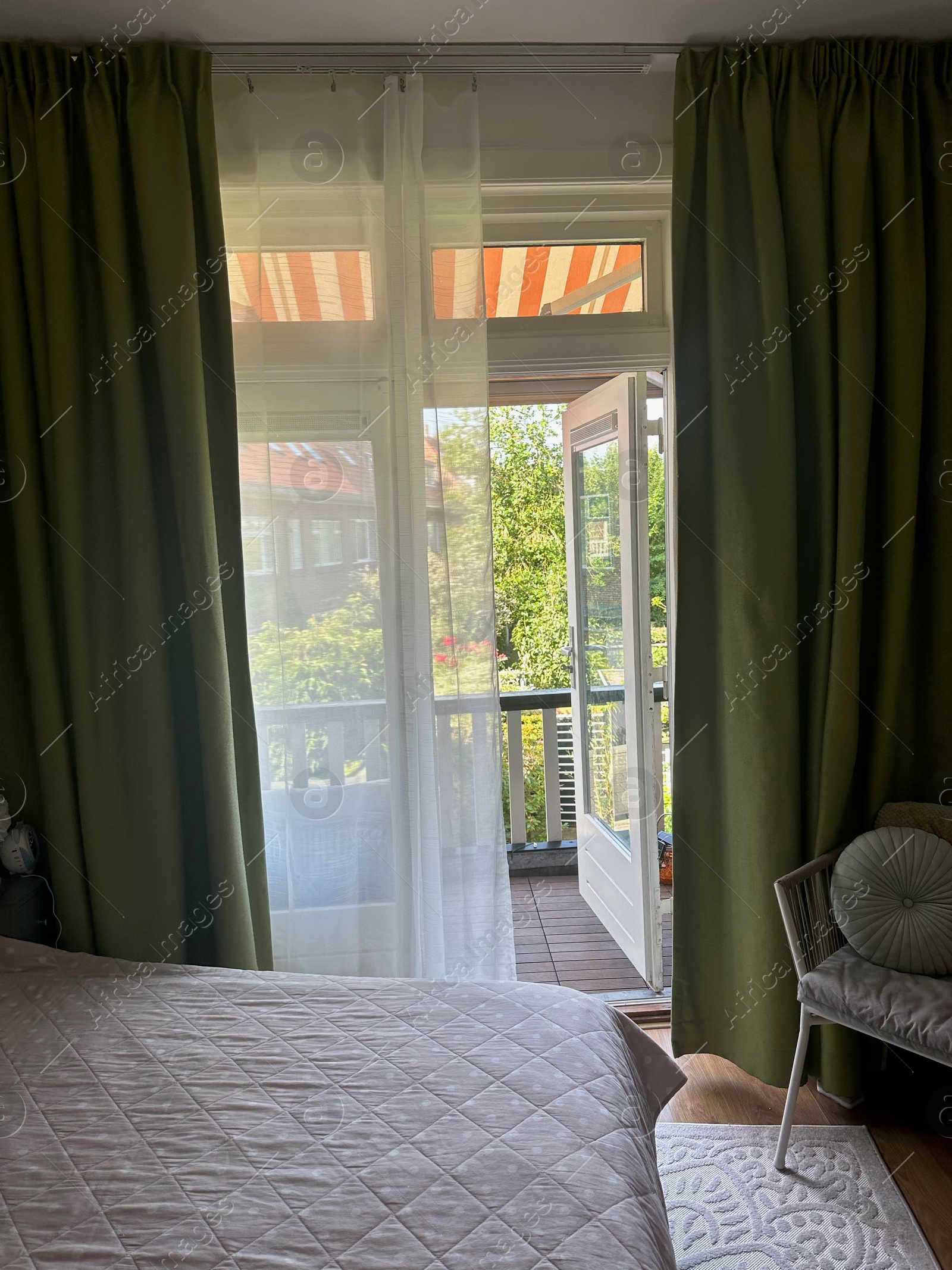 Stylish room with bed, curtains and balcony. Interior design Photo of Stylish room with bed, curtains and balcony. Interior design