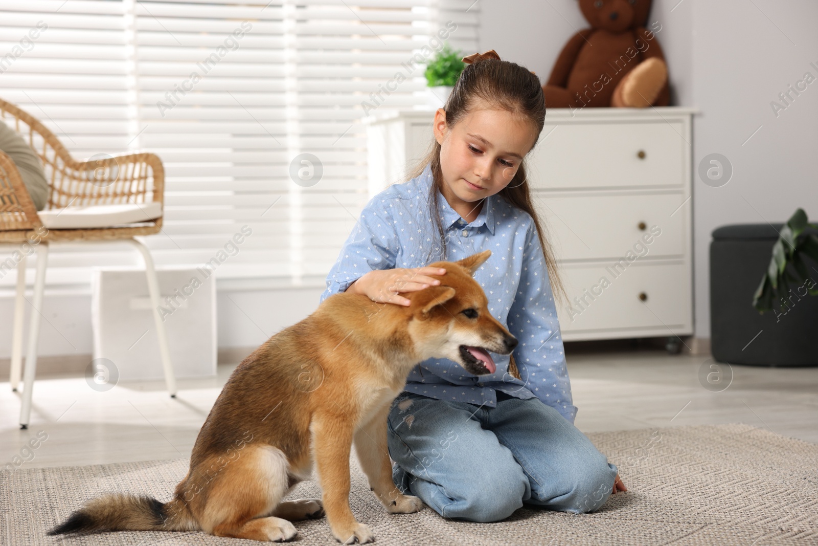 Cute little girl with her dog on floor at home. Child and pet Photo of Cute little girl with her dog on floor at home. Child and pet