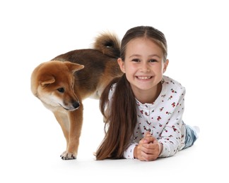Photo of Smiling little girl with her dog on white background. Child and pet
