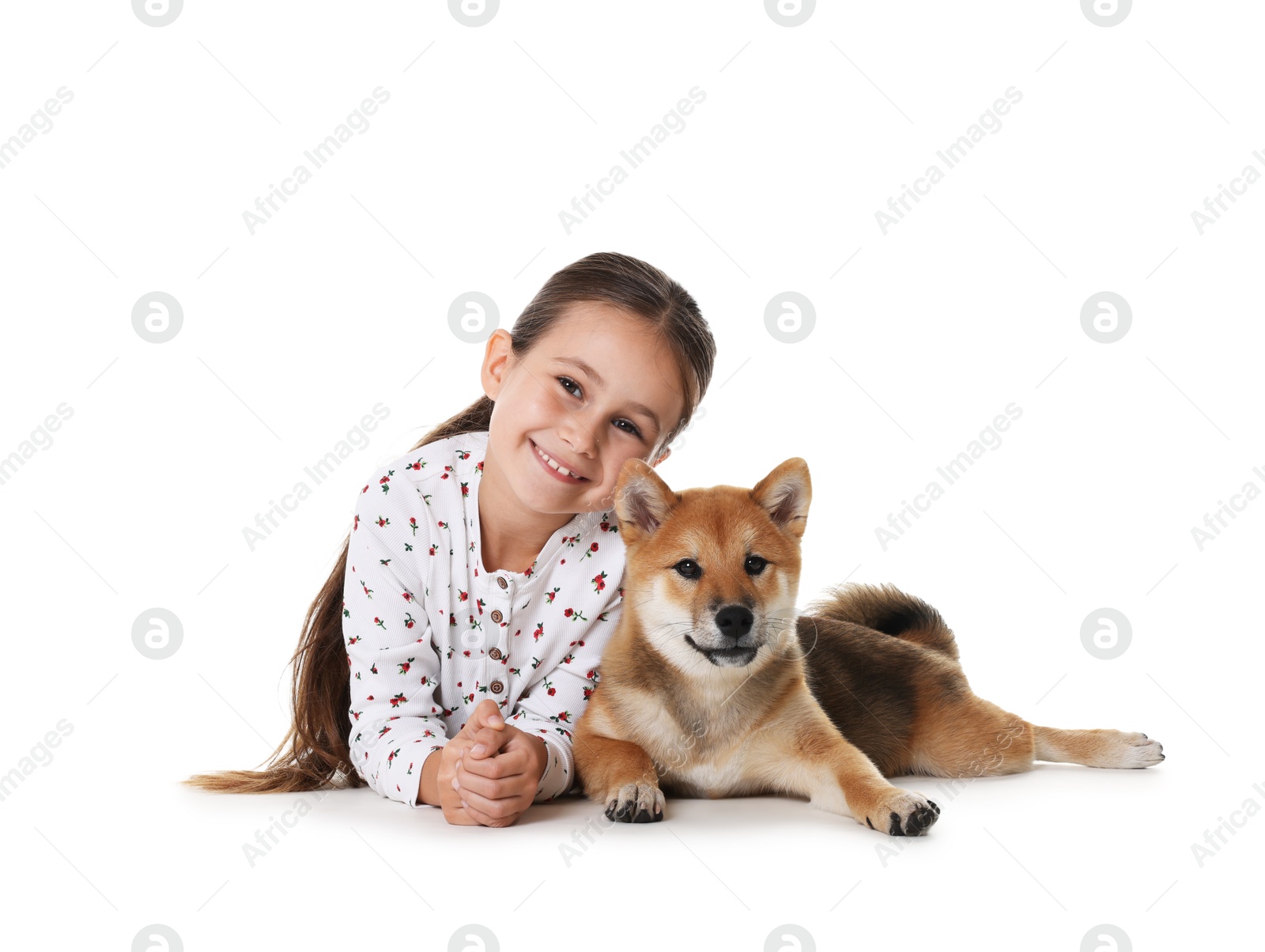 Photo of Portrait of smiling little girl with her dog on white background. Child and pet