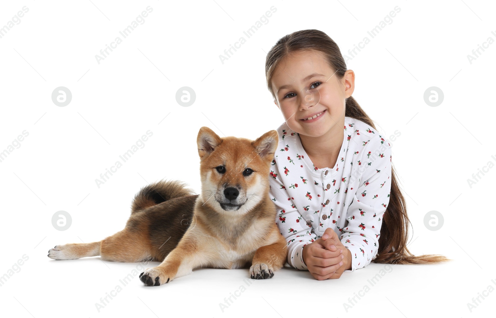 Photo of Portrait of smiling little girl with her dog on white background. Child and pet