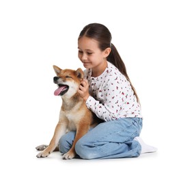 Photo of Cute little girl with her dog on white background. Child and pet