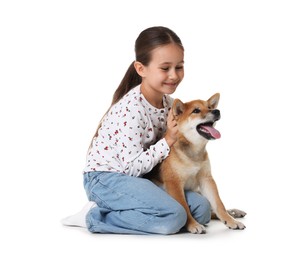 Photo of Smiling little girl with her dog on white background. Child and pet
