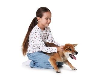 Photo of Cute little girl with her dog on white background. Child and pet