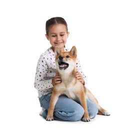 Photo of Smiling little girl with her dog on white background. Child and pet