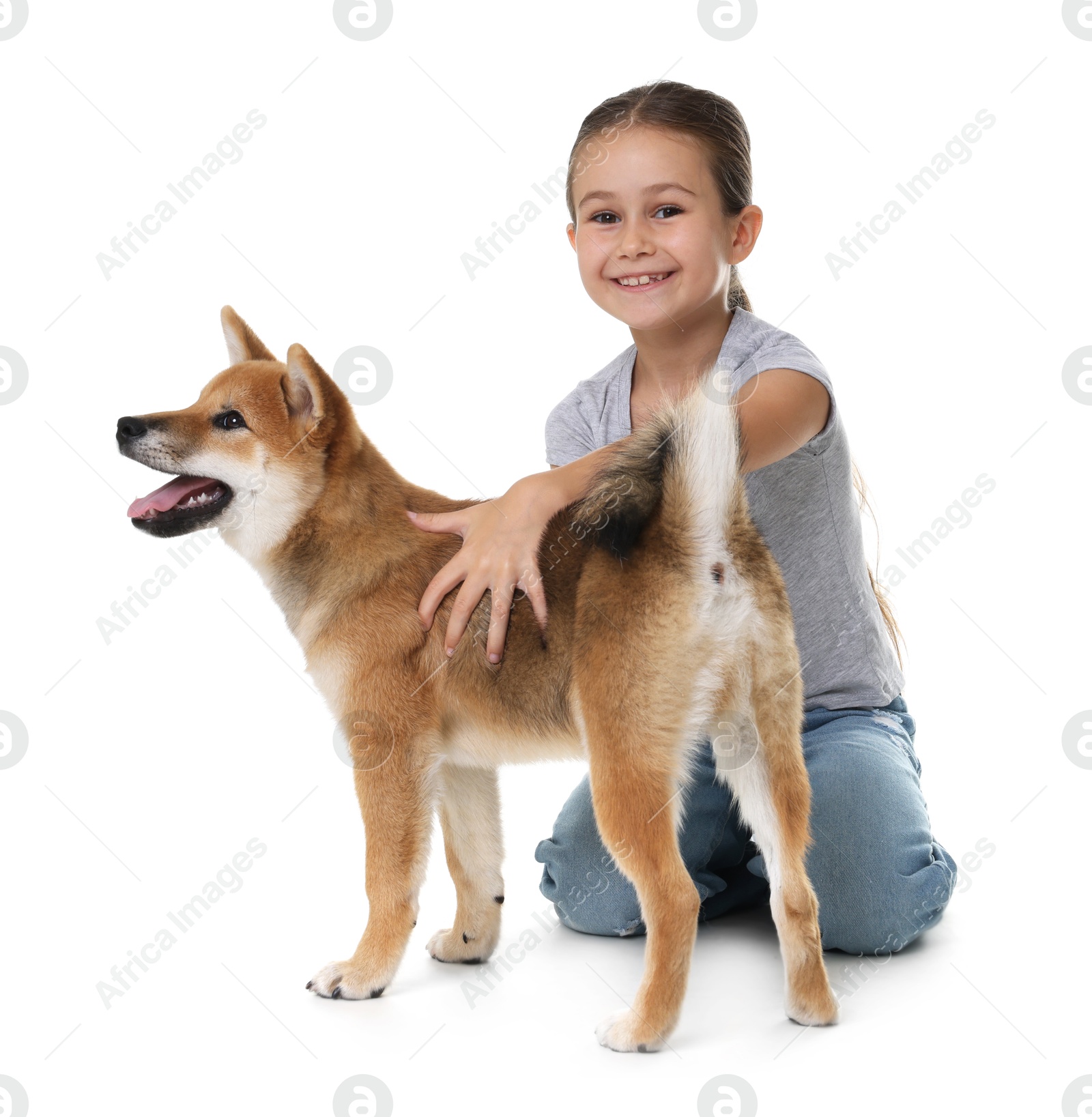 Smiling little girl with her dog on white background. Child and pet Photo of Smiling little girl with her dog on white background. Child and pet