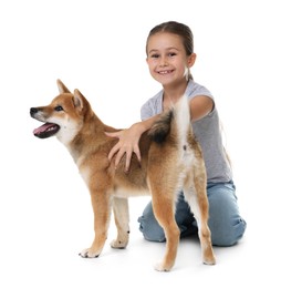 Photo of Smiling little girl with her dog on white background. Child and pet