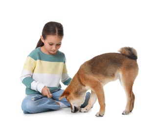 Photo of Cute little girl with her dog on white background. Child and pet