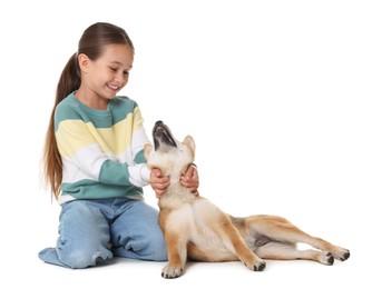 Photo of Smiling little girl with her dog on white background. Child and pet