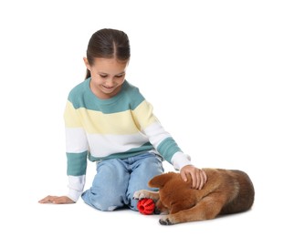 Photo of Smiling little girl and her dog with pet toy on white background