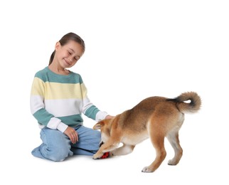 Photo of Cute little girl and her dog with pet toy on white background