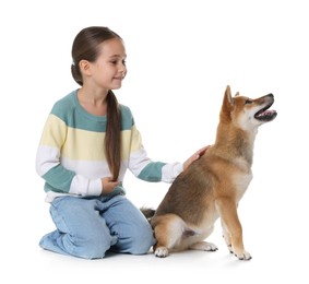 Photo of Smiling little girl with her dog on white background. Child and pet