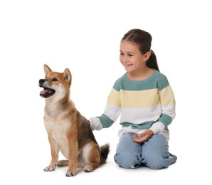 Photo of Smiling little girl with her dog on white background. Child and pet