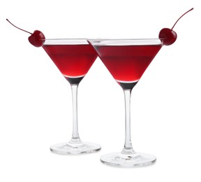 Photo of Martini cocktail with cherries in glasses on white background