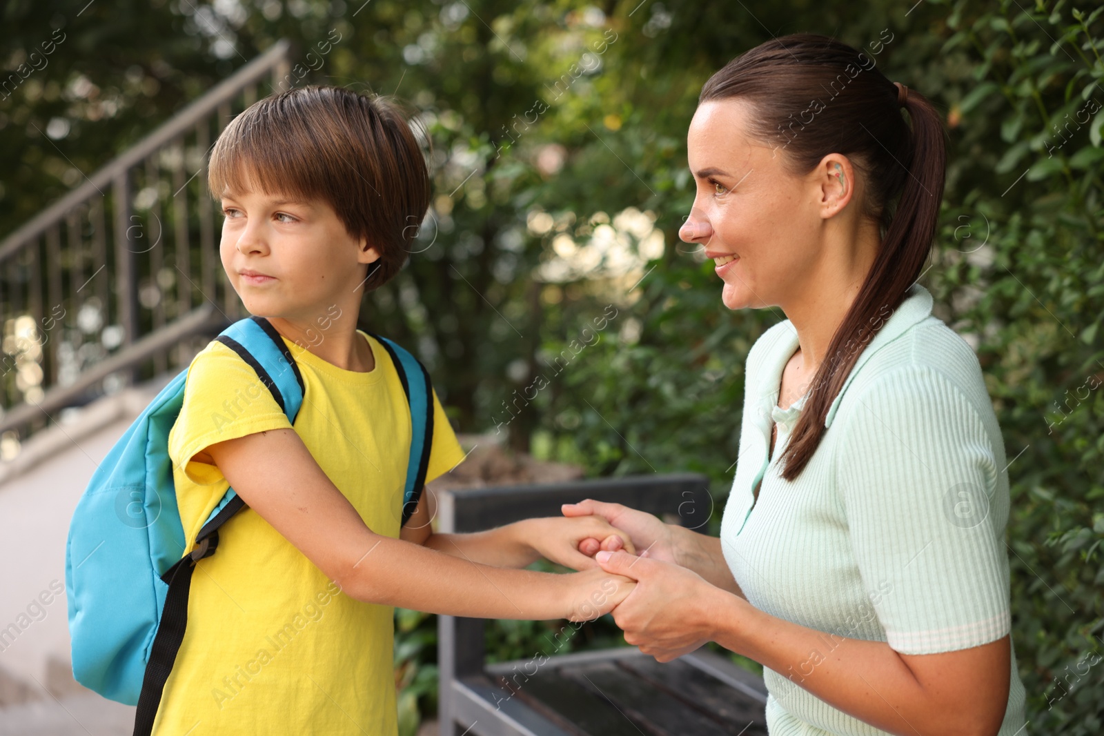 Photo of Mother taking her son to school outdoors