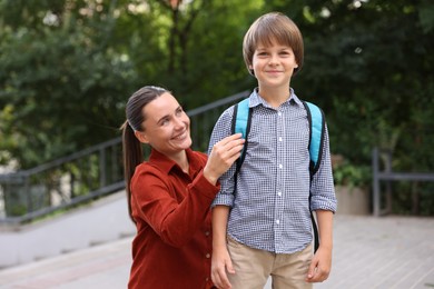 Photo of Mother taking her son to school outdoors