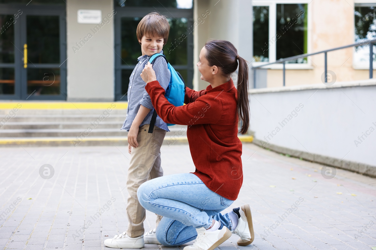 Photo of Mother taking her son to school outdoors