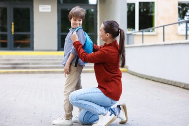 Photo of Mother taking her son to school outdoors