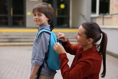 Photo of Mother taking her son to school outdoors