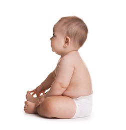 Photo of Cute little baby in diaper sitting on white background