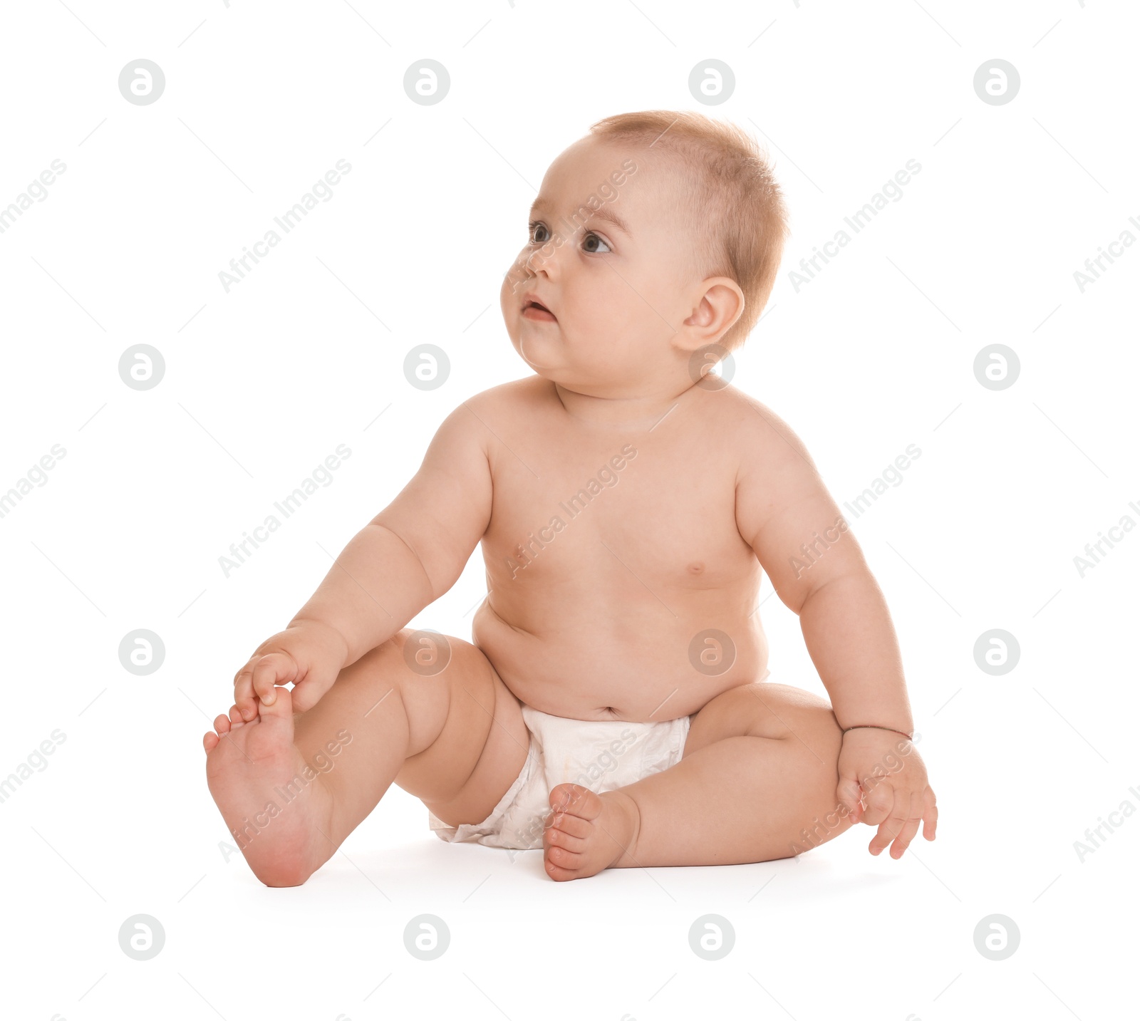 Photo of Cute little baby in diaper sitting on white background
