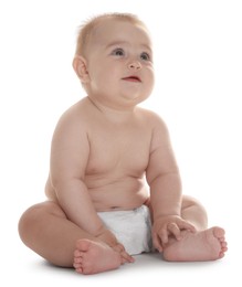 Photo of Cute little baby in diaper sitting on white background
