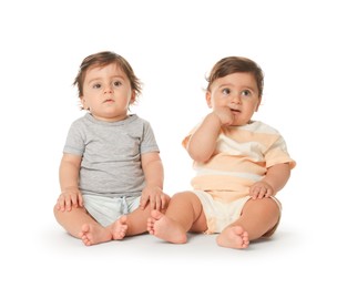 Photo of Cute little twin babies on white background