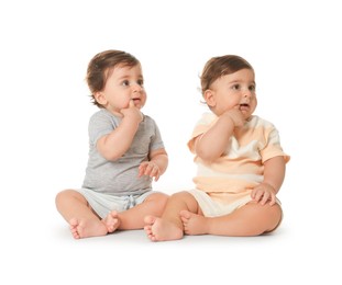 Photo of Cute little twin babies on white background