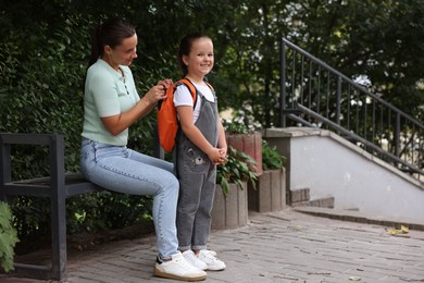 Photo of Mother taking her daughter to school outdoors