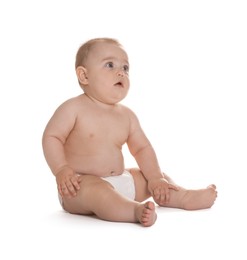 Photo of Cute little baby in diaper sitting on white background